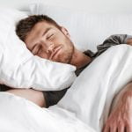 young man sleeping in bed