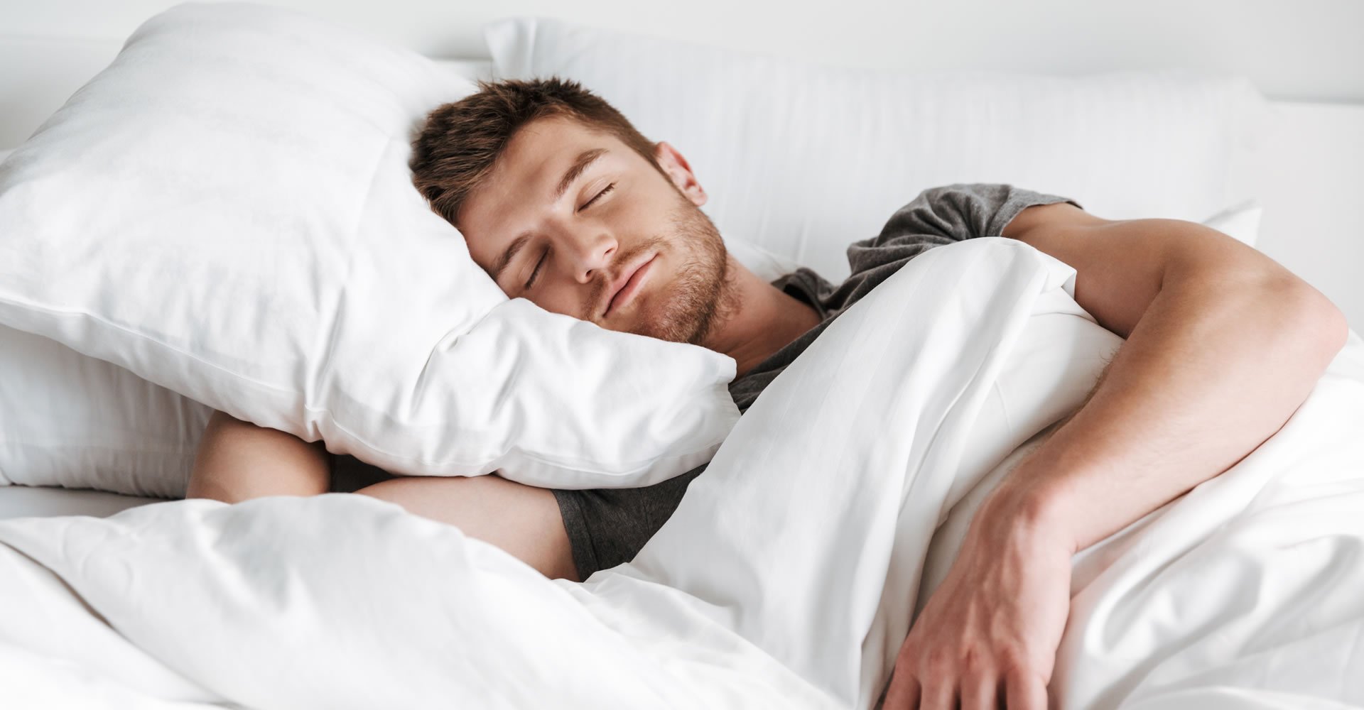 young man sleeping in bed