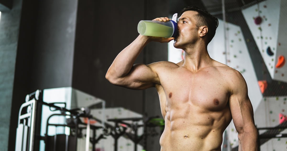 Man in gym drinking sports drink