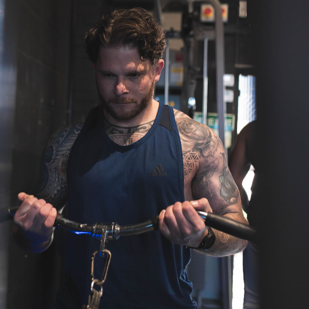 Person using machinery in Pysique Fit gym