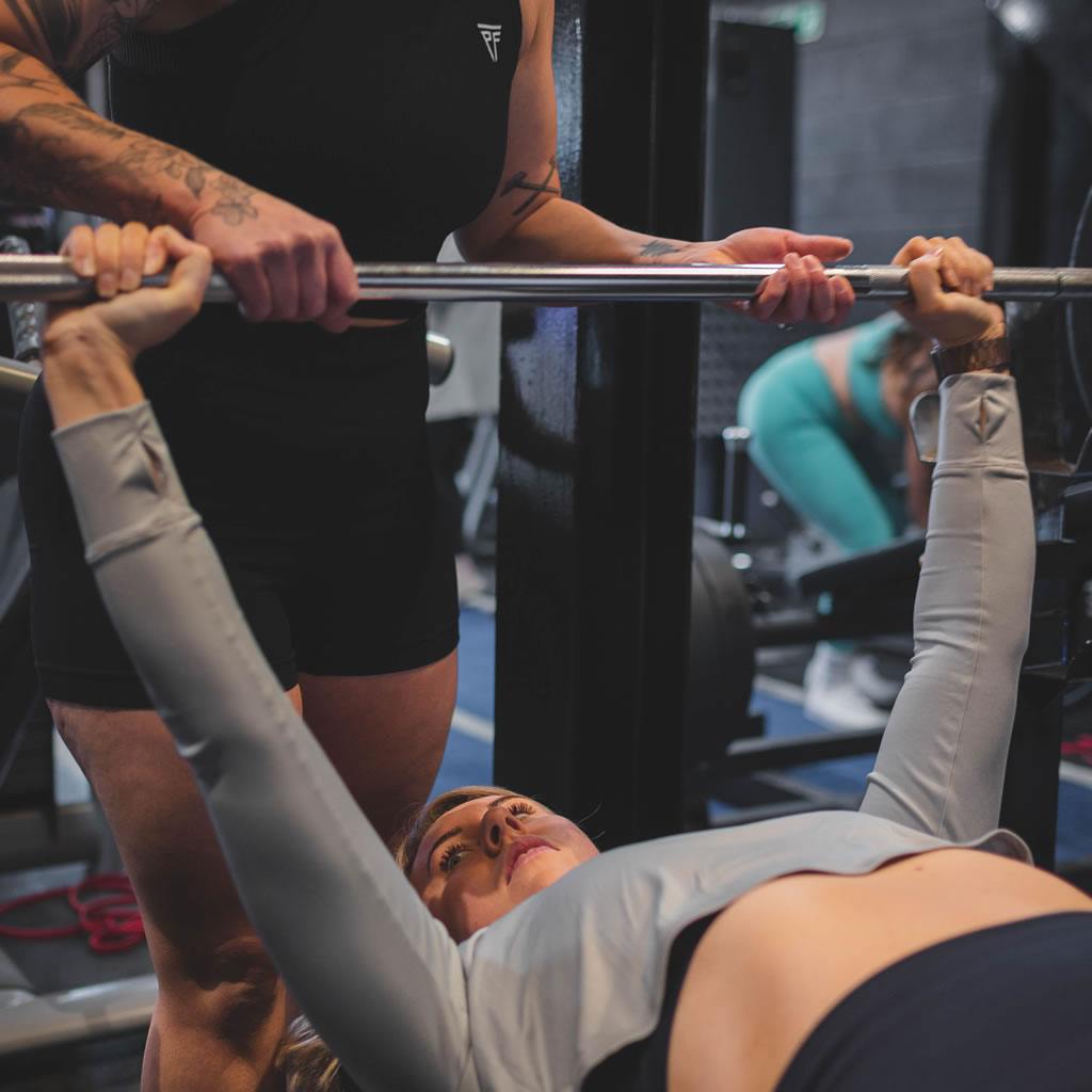 Person using equipment in Pysique Fit gym