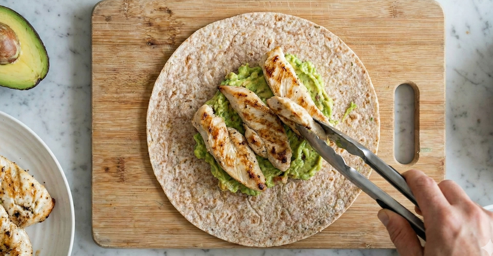 Close up of a chicken and avacado wrap being made